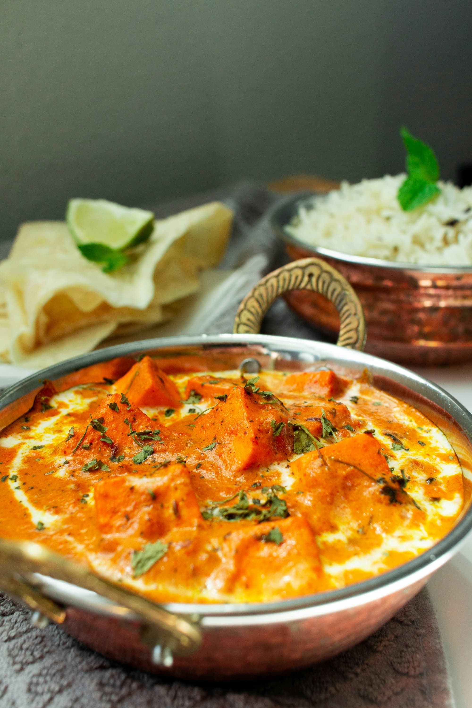 Rich butter chicken curry served with rice and roti